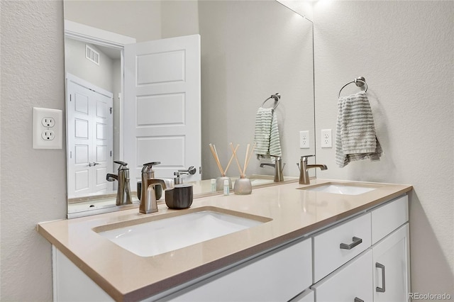 1575 W 68th Ave, Denver, CO 80221 - full bathroom featuring double vanity and a textured wall