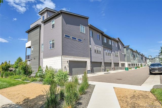 1575 W 68th Ave, Denver, CO 80221 - view of side of home featuring a residential view and a garage