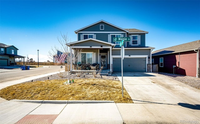 traditional-style home with a garage, covered porch, stone siding, and concrete driveway