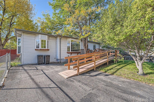 back of house featuring a yard and a wooden deck