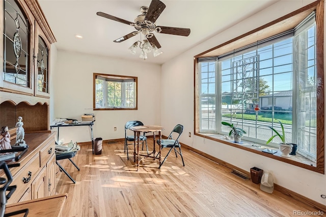 living area featuring light wood-type flooring and ceiling fan