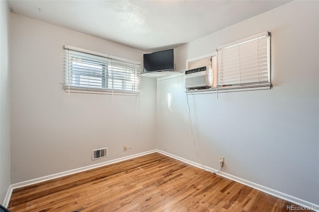 unfurnished room with wood-type flooring