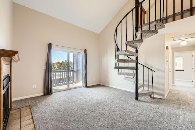 unfurnished living room featuring carpet flooring, high vaulted ceiling, and plenty of natural light