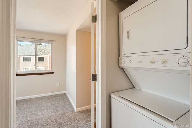 laundry area featuring light colored carpet and stacked washer / drying machine