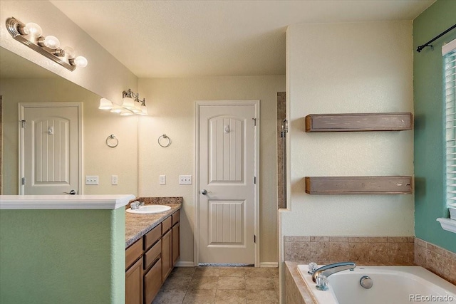 bathroom featuring tiled bath, vanity, and tile patterned floors