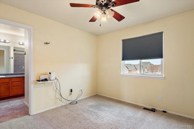 unfurnished room with light carpet, ceiling fan, and baseboards