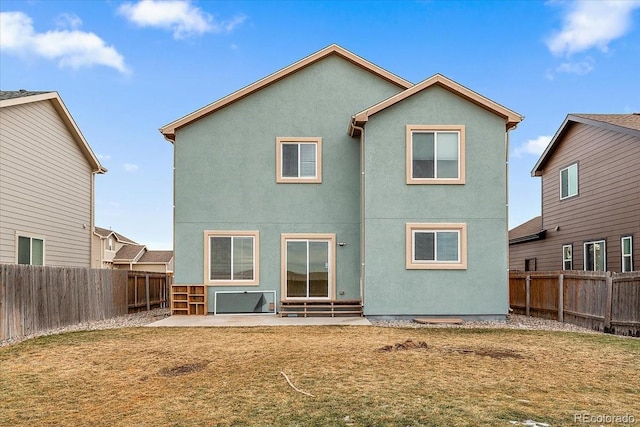 back of property featuring entry steps, a patio, a fenced backyard, and stucco siding