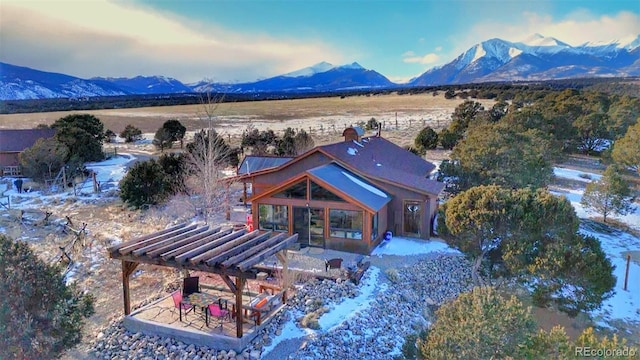 exterior space with a mountain view and a pergola