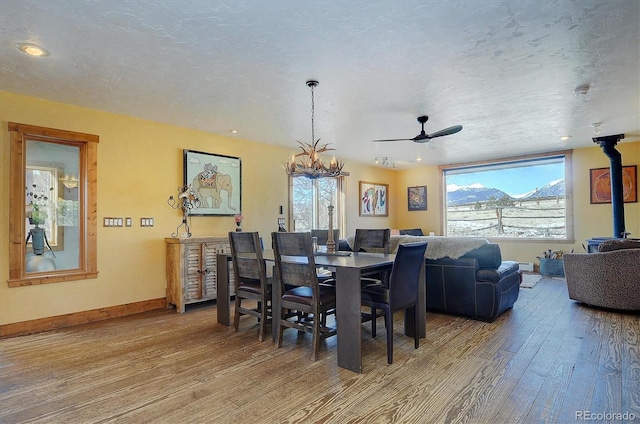 dining space featuring a chandelier, hardwood / wood-style floors, a textured ceiling, and a wealth of natural light