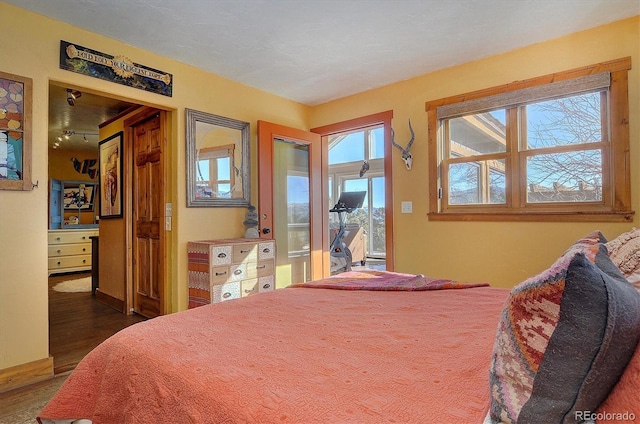 bedroom with dark wood-type flooring