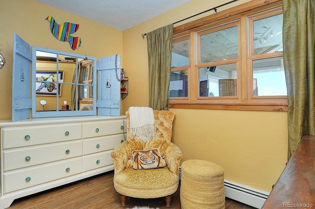 living area featuring a baseboard radiator and dark hardwood / wood-style floors