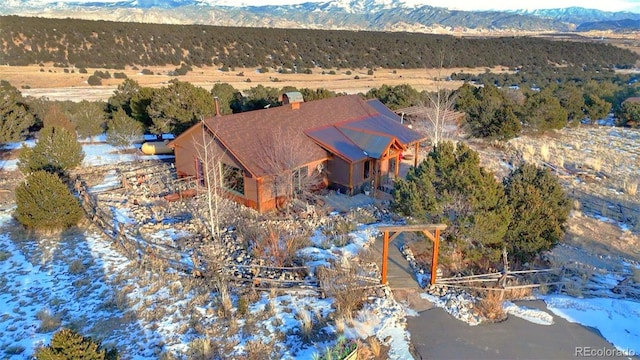 snowy aerial view featuring a mountain view