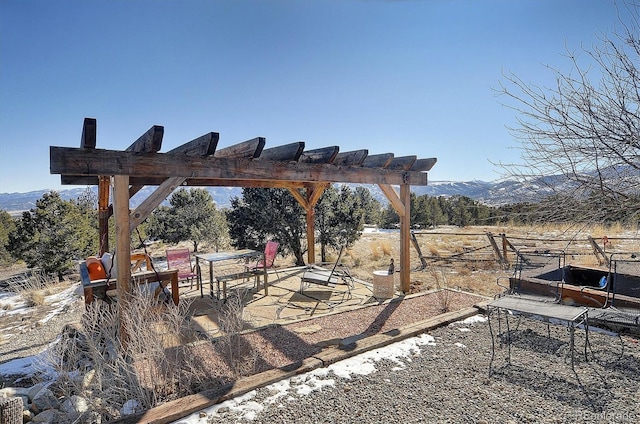 exterior space featuring a mountain view, a rural view, and a pergola