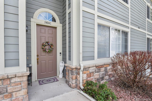entrance to property with stone siding