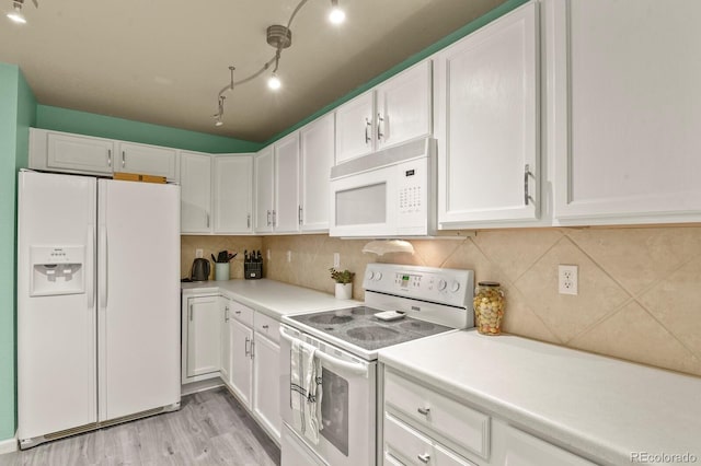 kitchen featuring light countertops, white cabinets, light wood-style floors, and white appliances
