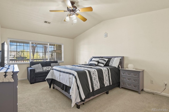 bedroom with vaulted ceiling, baseboards, light colored carpet, and visible vents