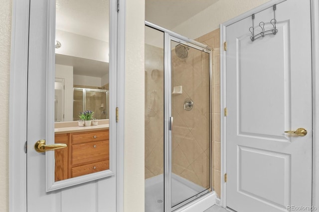 bathroom with vanity and a stall shower