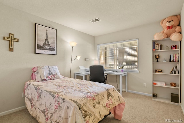 carpeted bedroom featuring visible vents and baseboards