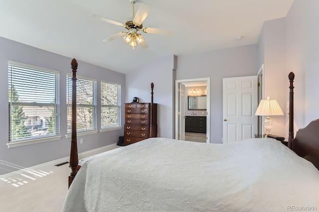 carpeted bedroom featuring visible vents, baseboards, a ceiling fan, ensuite bath, and vaulted ceiling