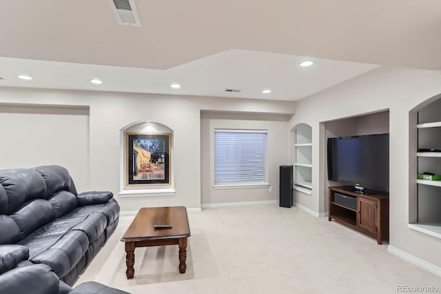 living area featuring visible vents, recessed lighting, and light colored carpet