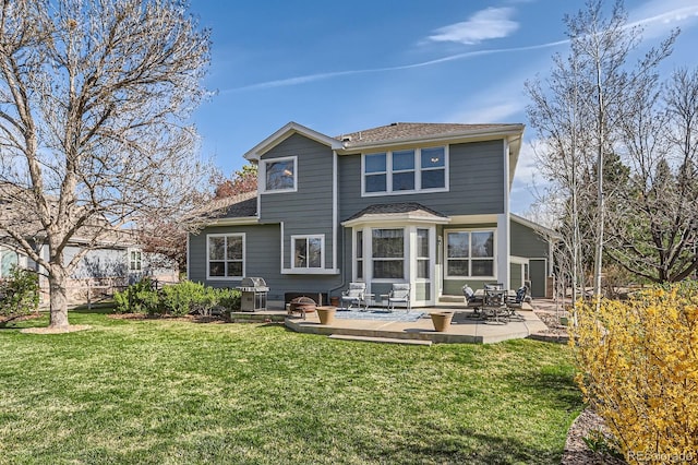 rear view of house with a patio area and a lawn