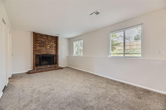 1758 S Ensenada St, Aurora, CO 80017 - unfurnished living room featuring carpet, a brick fireplace, and baseboards