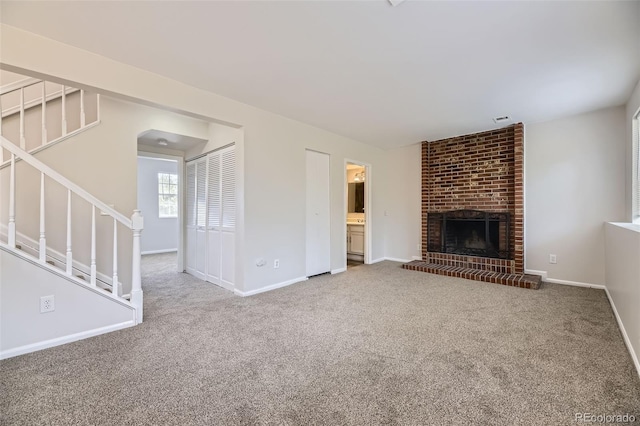 1758 S Ensenada St, Aurora, CO 80017 - unfurnished living room with carpet, stairway, a fireplace, and baseboards