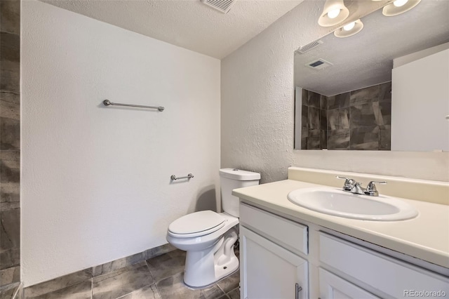 1758 S Ensenada St, Aurora, CO 80017 - full bath featuring toilet, vanity, a textured ceiling, and a textured wall