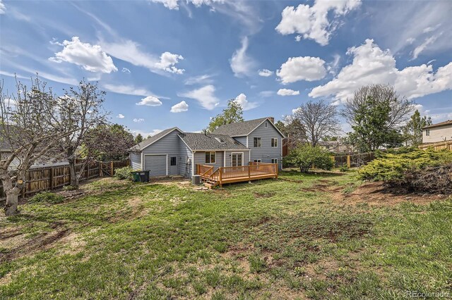 1758 S Ensenada St, Aurora, CO 80017 - back of property with a deck and an attached garage