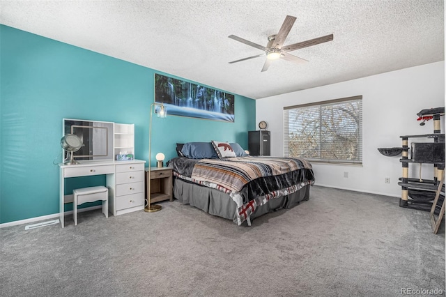 carpeted bedroom with ceiling fan, baseboards, and a textured ceiling