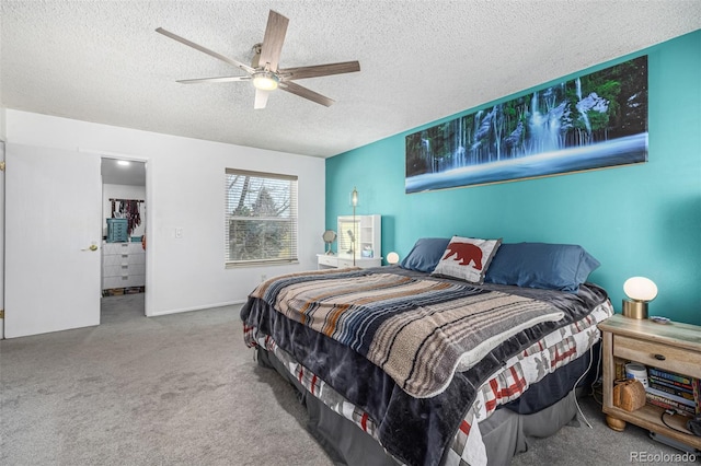 bedroom with a textured ceiling, carpet floors, and a ceiling fan