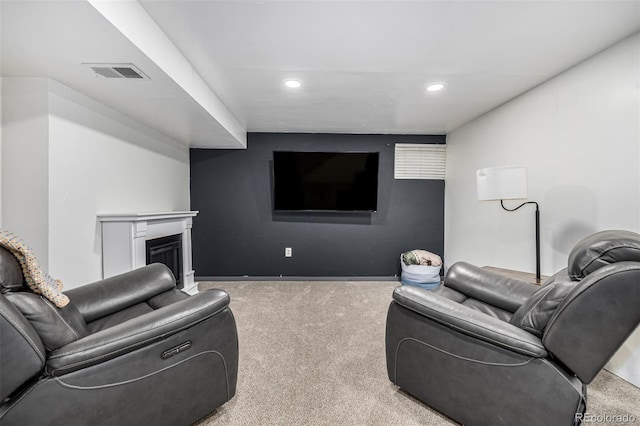 carpeted living area featuring baseboards, a fireplace, visible vents, and recessed lighting