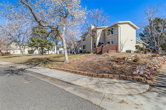 view of property exterior featuring a wooden deck