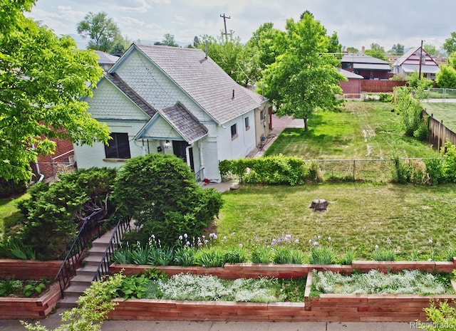2809 Yates St, Denver, CO 80212 - view of side of property with a fenced backyard and a garden