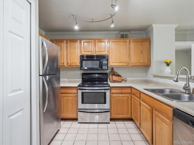 12348 W Dorado Pl Unit 204, Littleton, CO 80127 - kitchen featuring stainless steel appliances, a sink, light countertops, light tile patterned floors, and crown molding