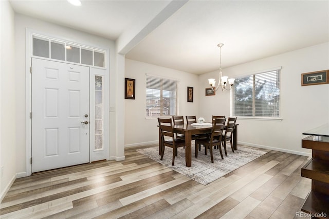 dining area with a notable chandelier and light wood-type flooring