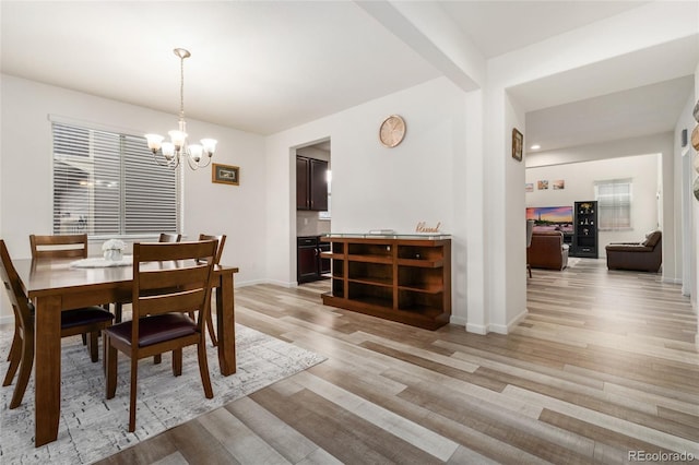 dining area featuring a chandelier and light hardwood / wood-style floors