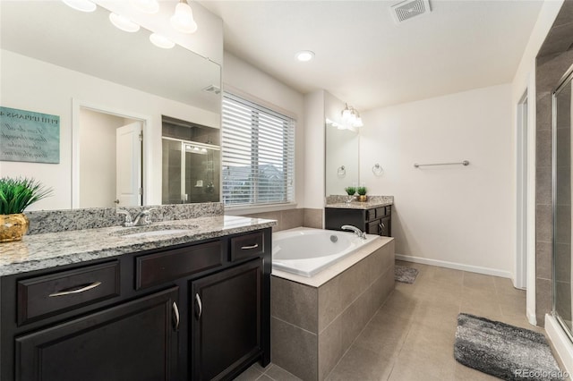 bathroom featuring tile patterned floors, vanity, and shower with separate bathtub