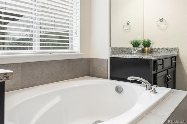 bathroom featuring vanity and a tub