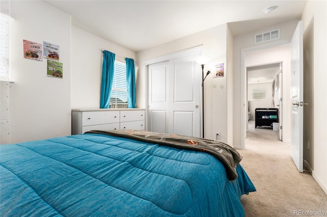 carpeted bedroom with a closet