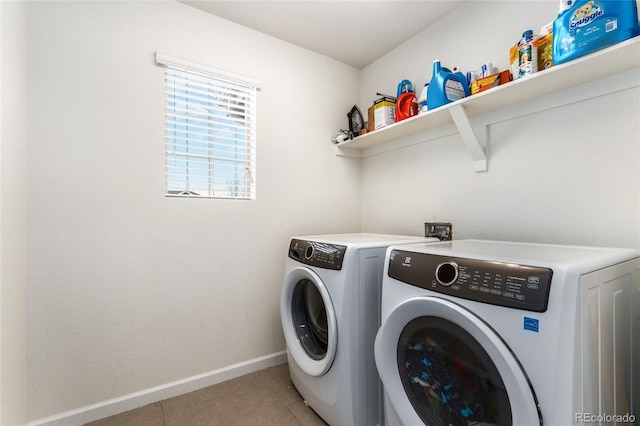 laundry room with separate washer and dryer and light tile patterned floors