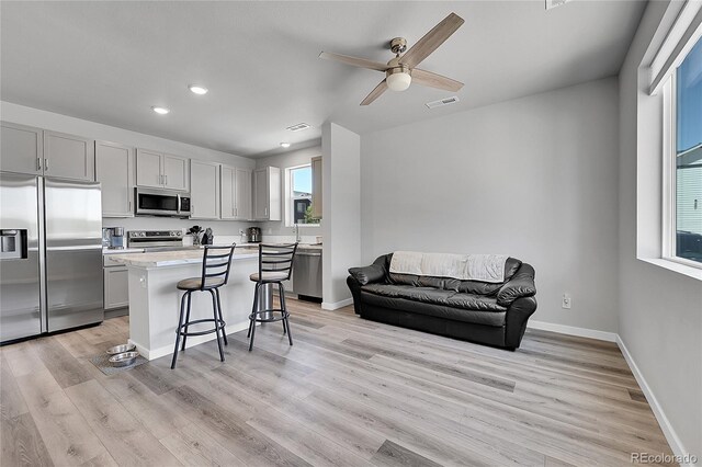 620 Apache Trl Unit A1, Ault, CO 80610 - kitchen with appliances with stainless steel finishes, a kitchen breakfast bar, a center island, recessed lighting, and light countertops
