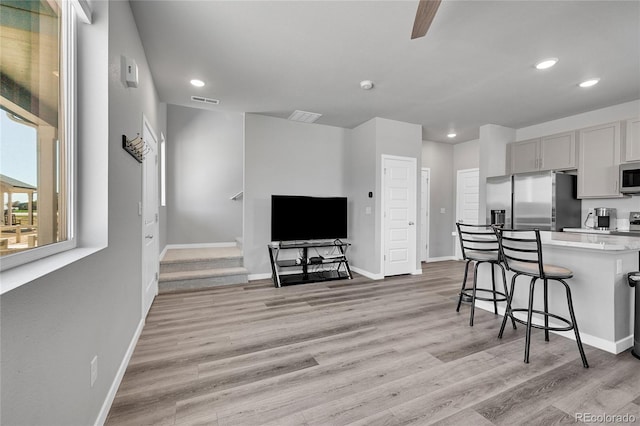 620 Apache Trl Unit A1, Ault, CO 80610 - kitchen featuring stainless steel appliances, a breakfast bar area, recessed lighting, light wood-type flooring, and light countertops