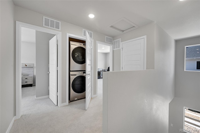 620 Apache Trl Unit A1, Ault, CO 80610 - laundry area featuring stacked washer / dryer, light colored carpet, and attic access