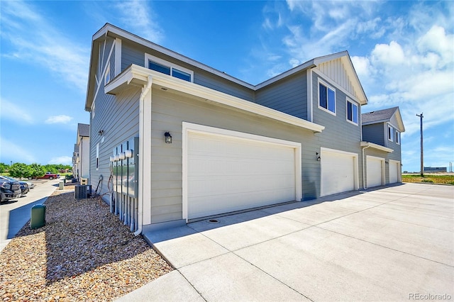 620 Apache Trl Unit A1, Ault, CO 80610 - view of side of property with driveway, an attached garage, and board and batten siding