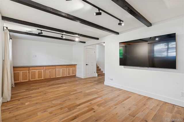 4634 W Tufts Cir, Denver, CO 80236 - unfurnished room featuring rail lighting, beamed ceiling, stairway, and light wood finished floors