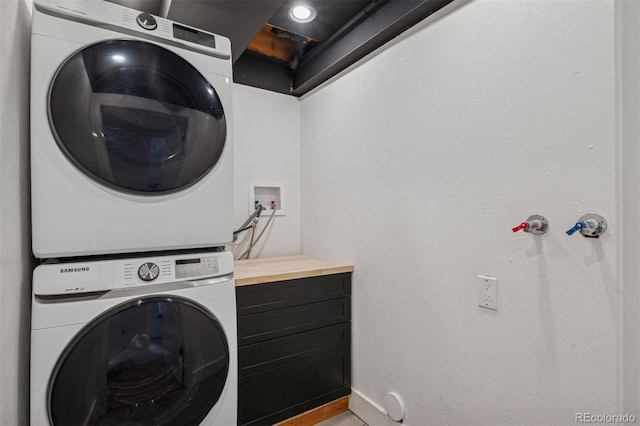 4634 W Tufts Cir, Denver, CO 80236 - laundry room featuring stacked washing machine and dryer and baseboards