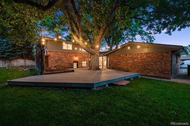 4634 W Tufts Cir, Denver, CO 80236 - back of property featuring brick siding and a wooden deck