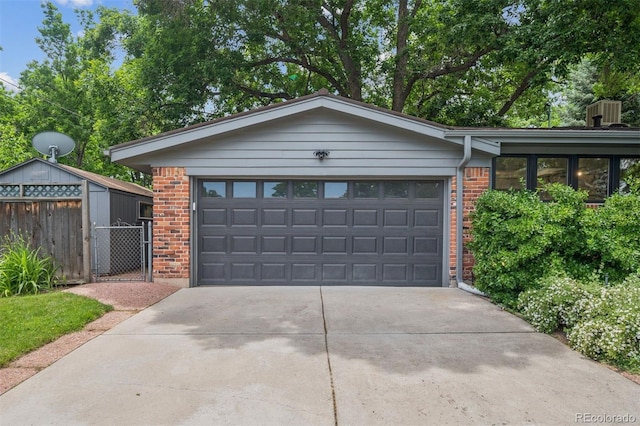 4634 W Tufts Cir, Denver, CO 80236 - garage with concrete driveway and a gate