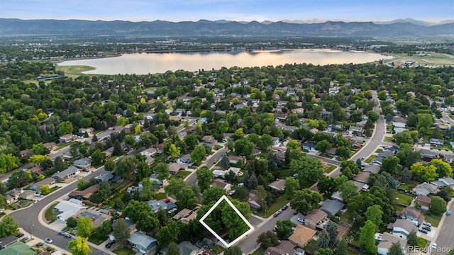 4634 W Tufts Cir, Denver, CO 80236 - aerial view of property and surrounding area featuring a water and mountain view and property boundaries highlighted